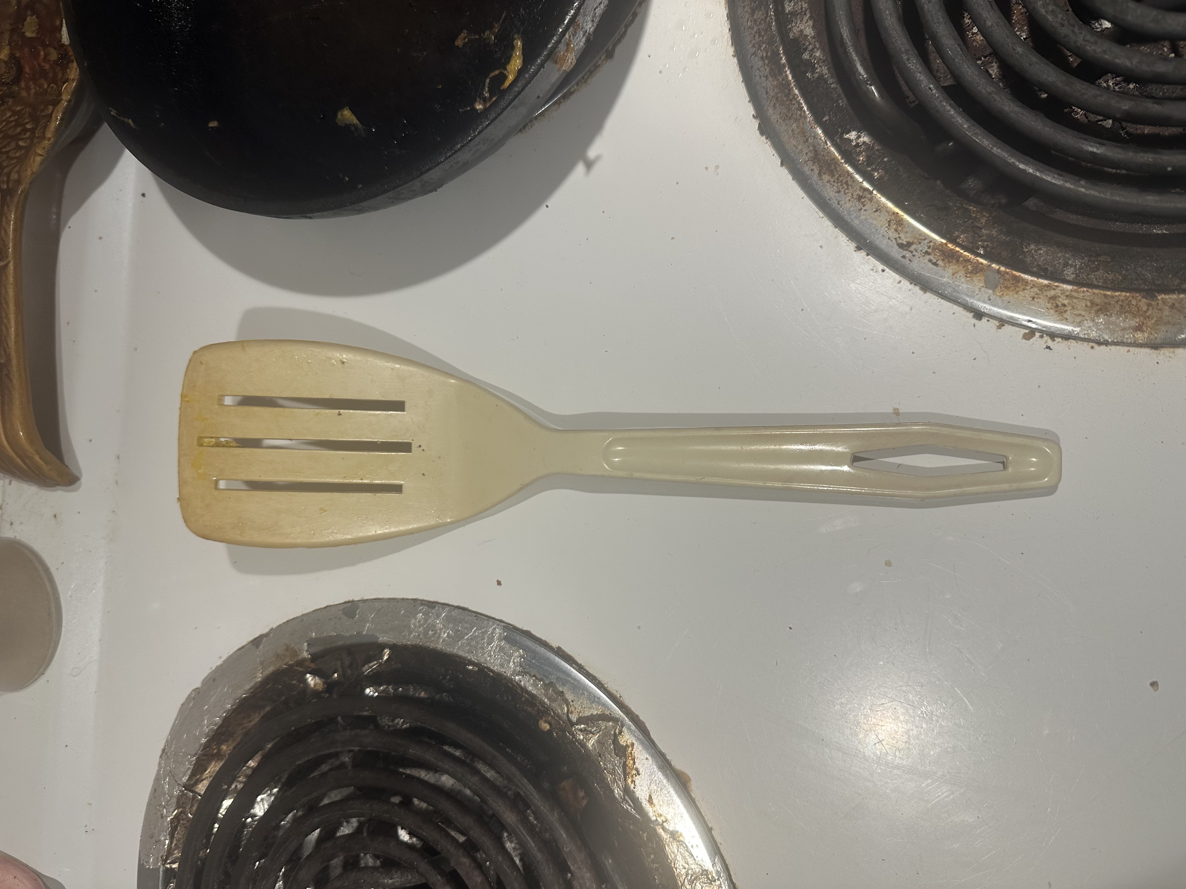 Silicone spatula with egg residue on stove